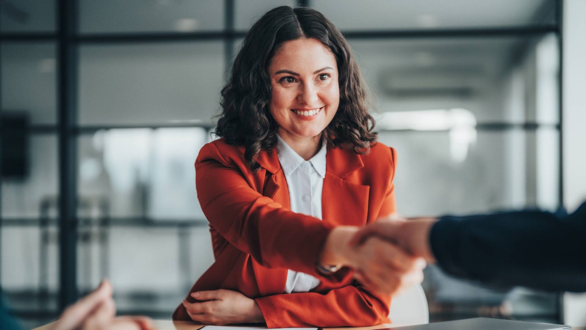 Professional woman shaking hands at meeting