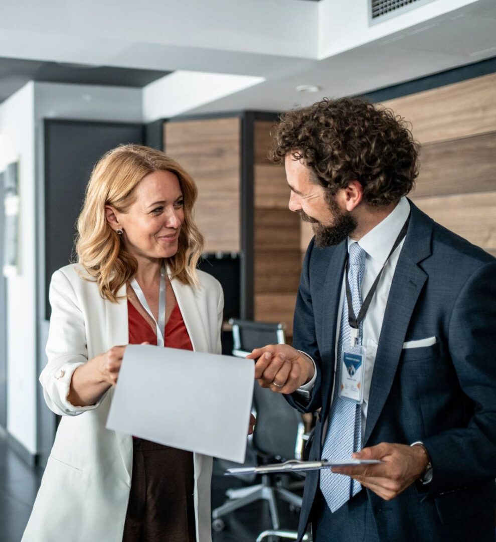 Professionals sharing paperwork in office